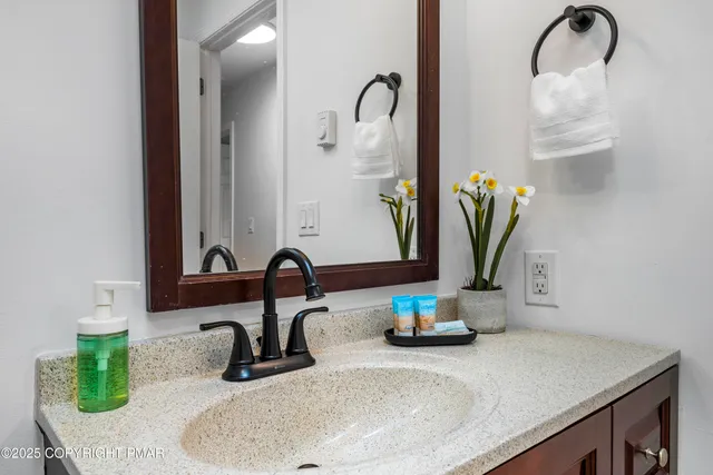 a bathroom with a sink and a mirror