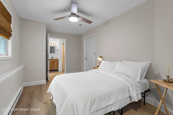 a bedroom with a large bed and a chandelier