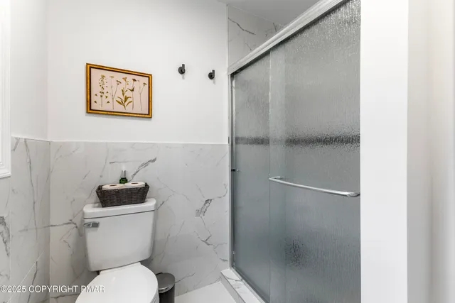 a white toilet sitting next to a bathroom sink