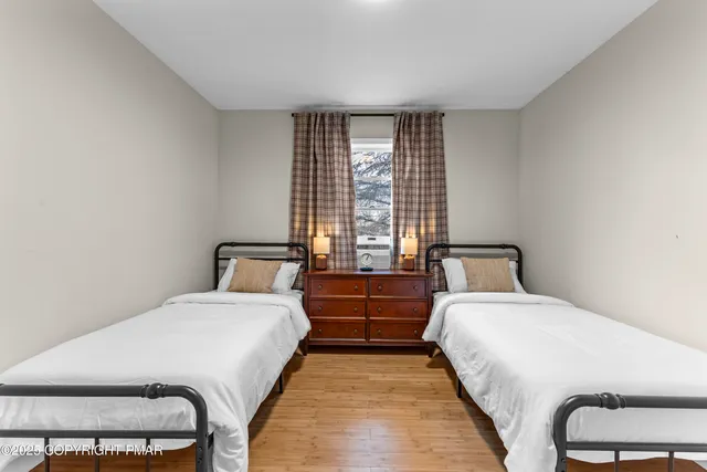 a bed room with two bed and a lamp