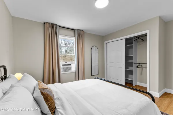 a bedroom with a bed and a window