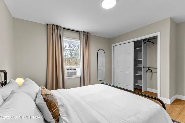 a bedroom with a bed and a window