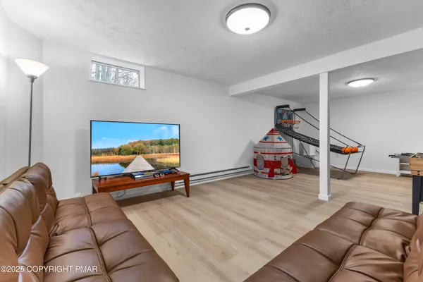 a living room with furniture gym equipment and a flat screen tv