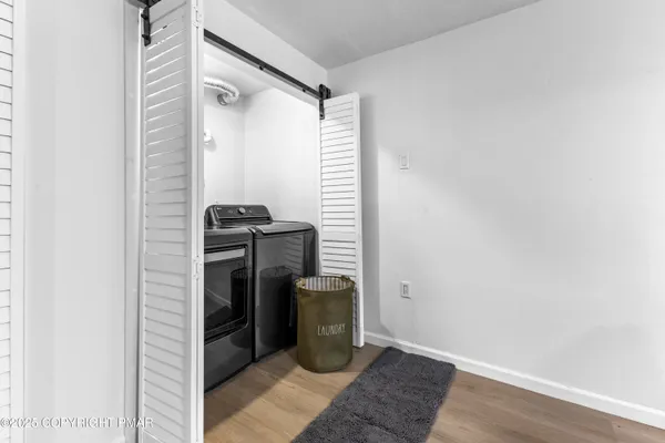 a view of a storage and utility room with washer and dryer