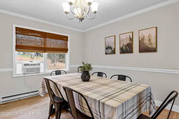 a dining room with a table and chairs