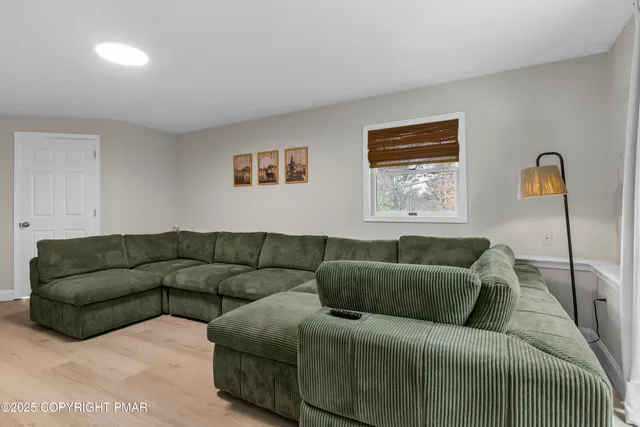 a living room with a couch and a window