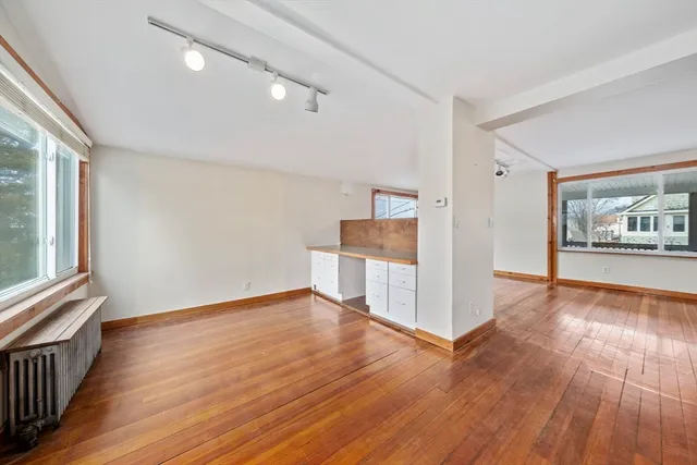 a view of a roof deck with wooden floor and fence