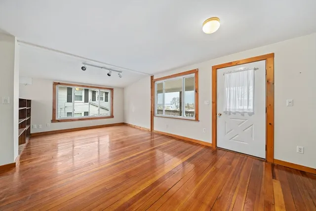 wooden floor in an empty room with a window