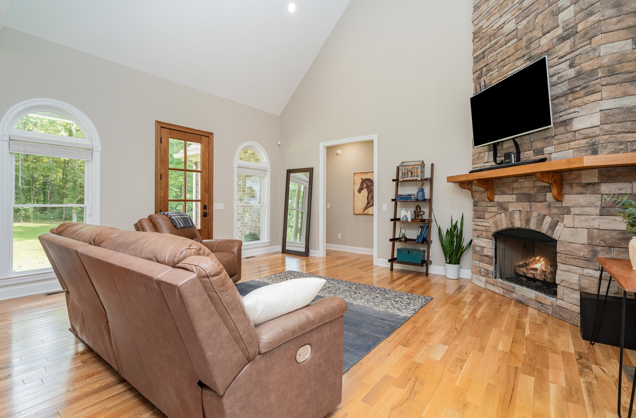 3395 Shouse Road Santa Fe, TN 38482 - Photo 6 of 73 a living room with furniture a flat screen tv and a fireplace