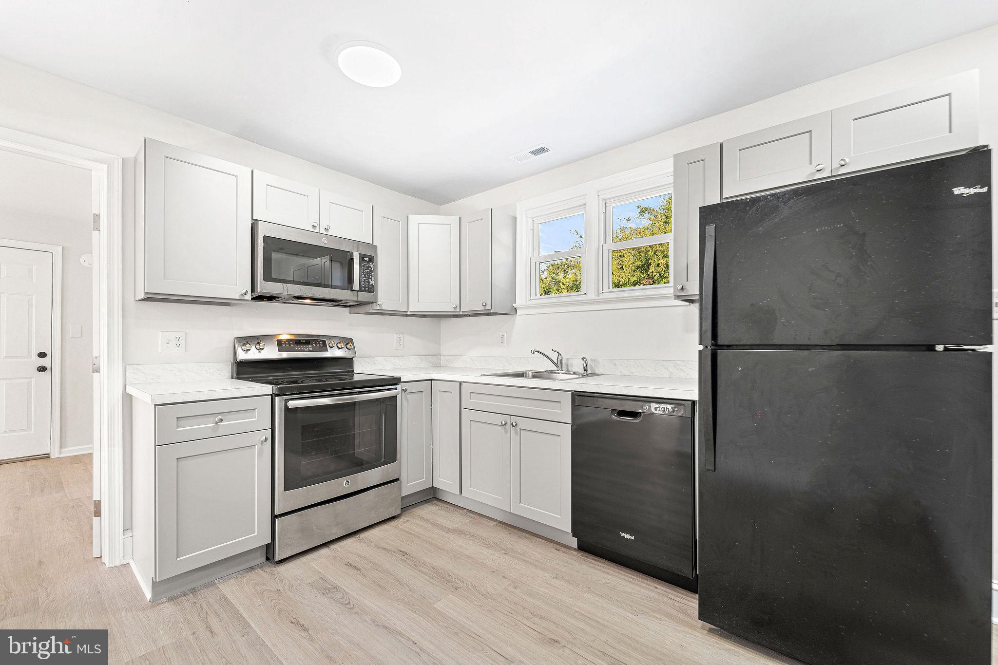 115 Chestnut Street Salem, NJ 08079 - Photo 12 of 34 a kitchen with a refrigerator stove and microwave