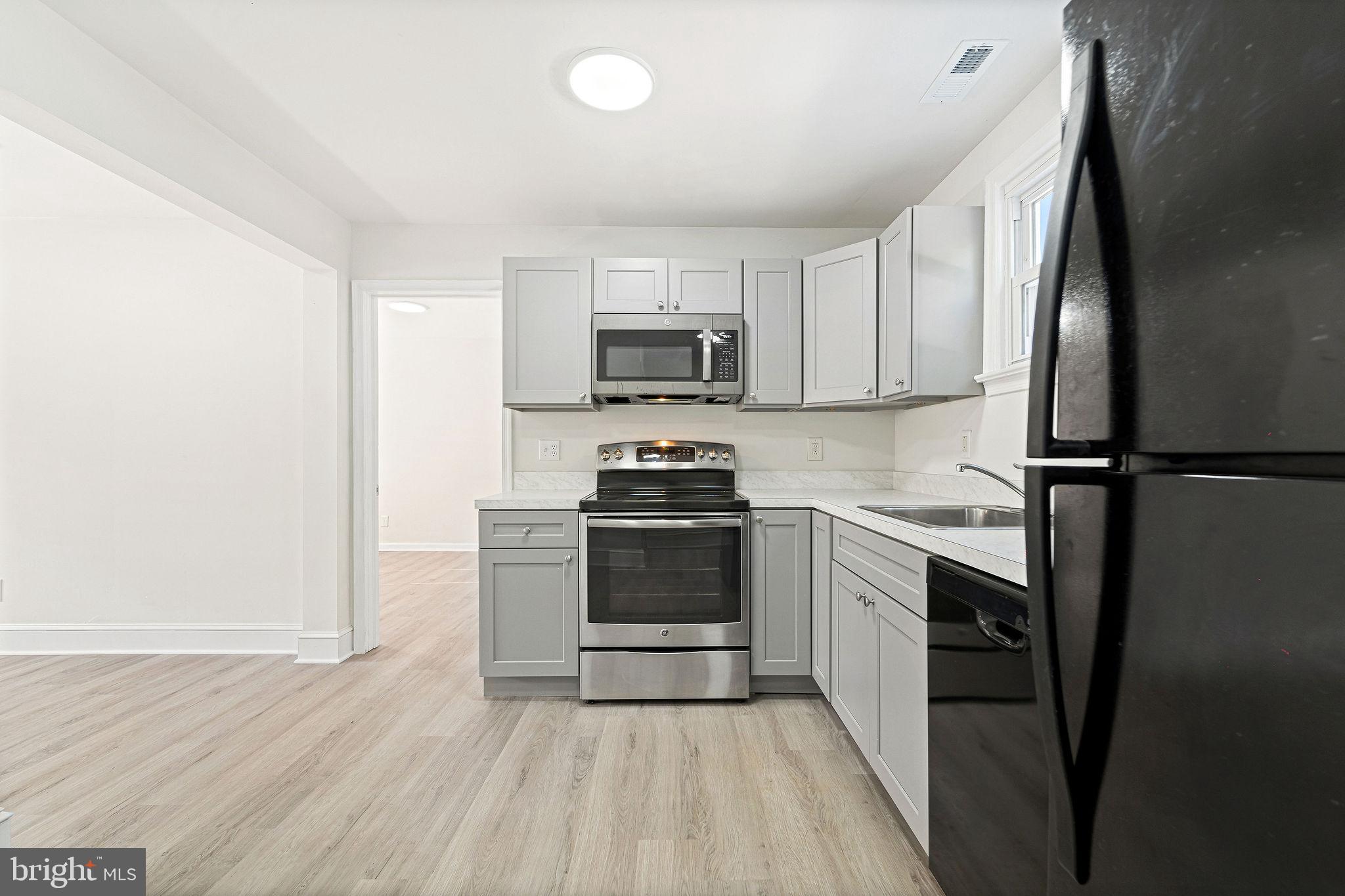 115 Chestnut Street Salem, NJ 08079 - Photo 13 of 34 a kitchen with granite countertop a refrigerator stove and sink