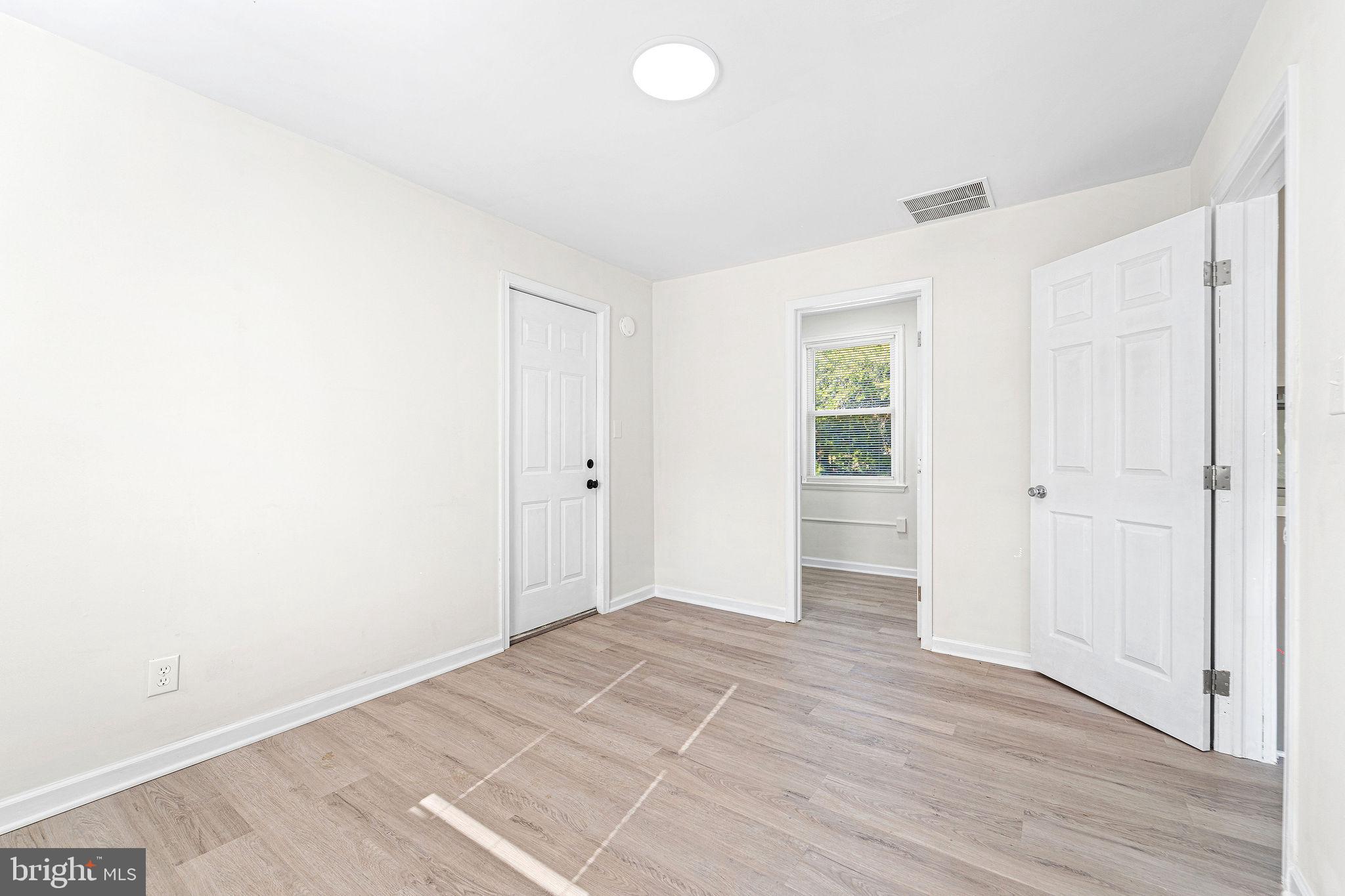115 Chestnut Street Salem, NJ 08079 - Photo 15 of 34 an empty room with wooden floor and windows