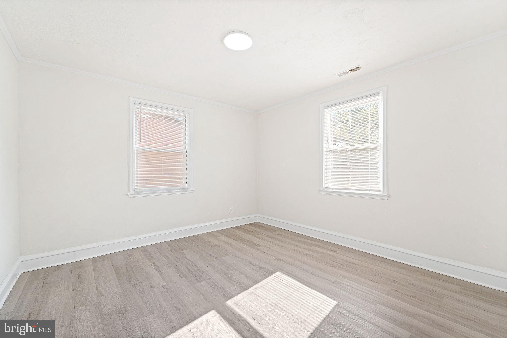 115 Chestnut Street Salem, NJ 08079 - Photo 22 of 34 an empty room with wooden floor and windows