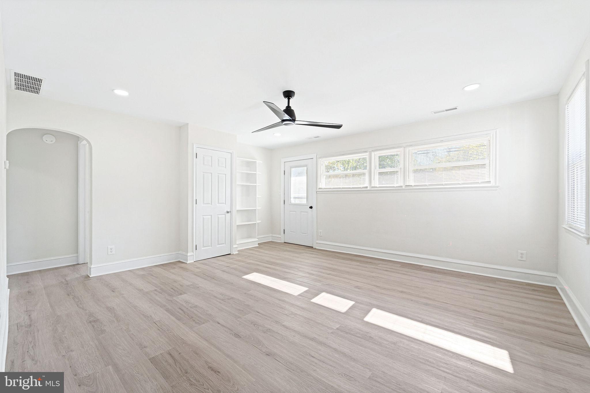 115 Chestnut Street Salem, NJ 08079 - Photo 4 of 34 an empty room with wooden floor and windows