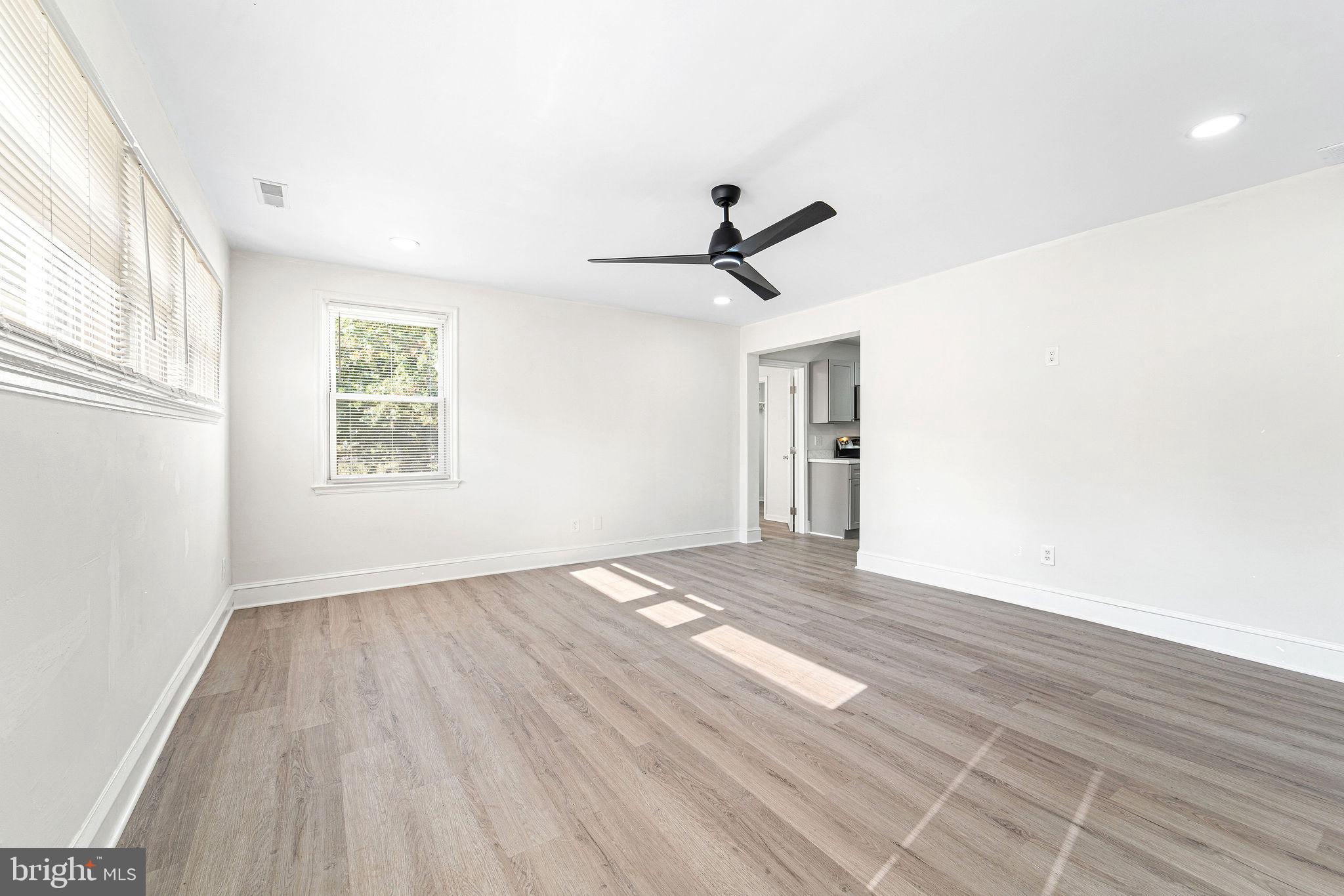 115 Chestnut Street Salem, NJ 08079 - Photo 5 of 34 a view of empty room with wooden floor and fan