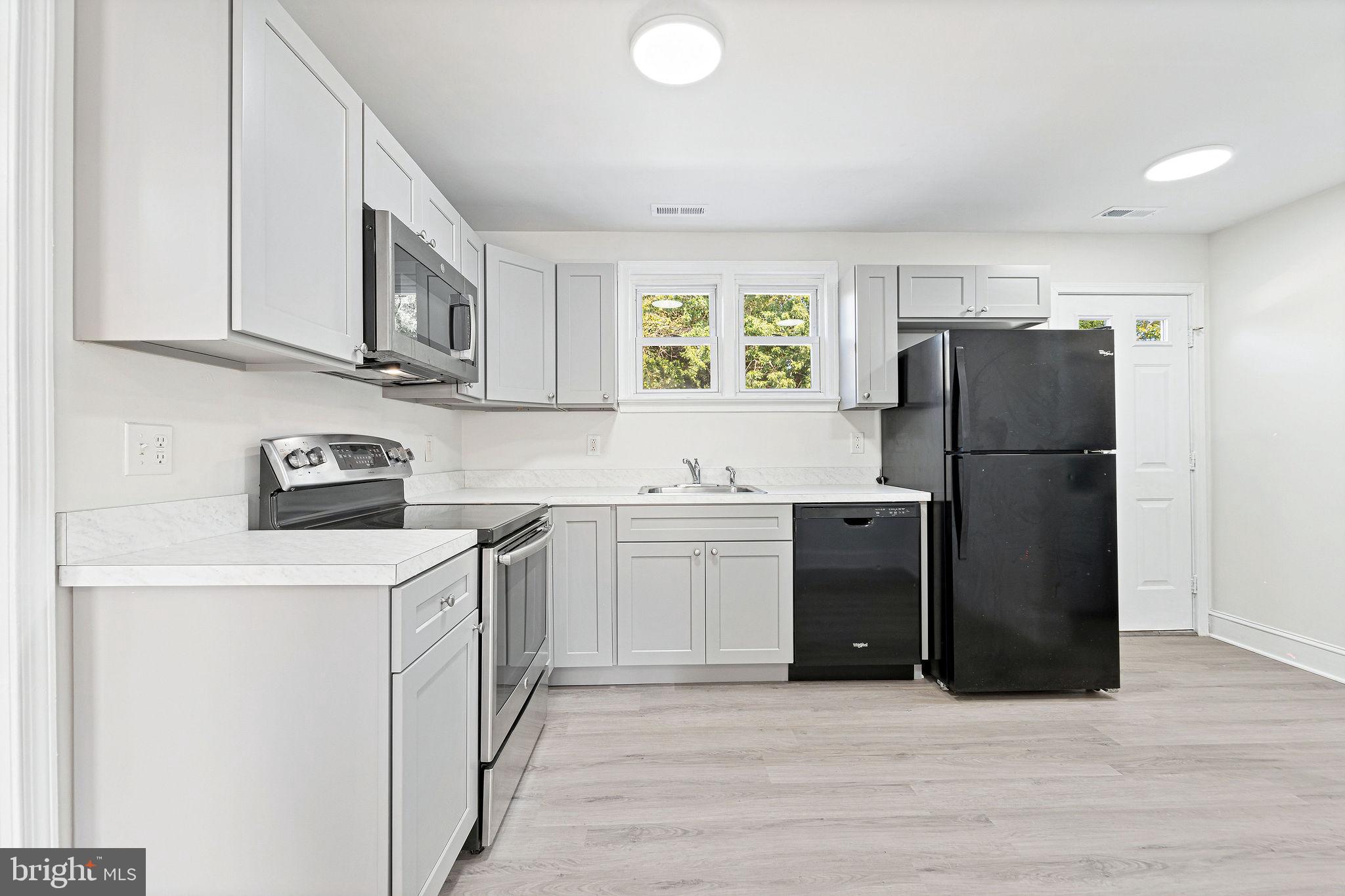 115 Chestnut Street Salem, NJ 08079 - Photo 8 of 34 a kitchen with stainless steel appliances granite countertop a refrigerator and a stove