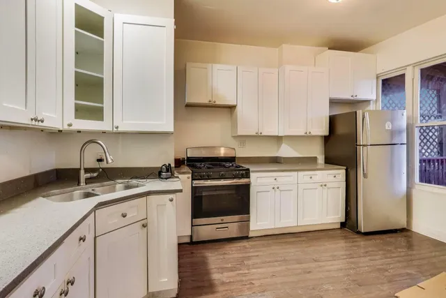 a kitchen with a sink stove and refrigerator