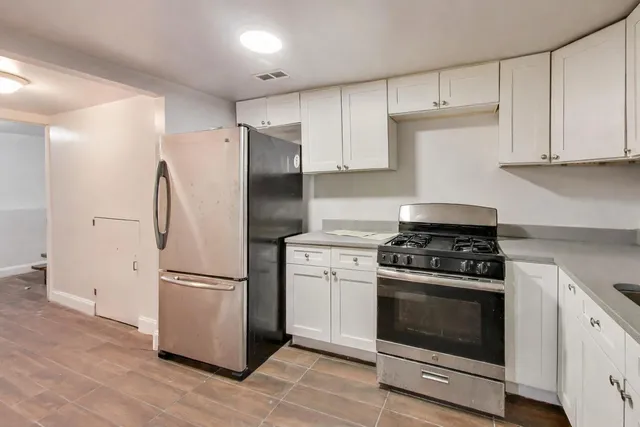 a kitchen with a stove refrigerator and cabinets