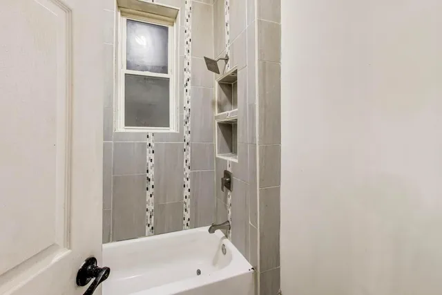 a bathroom with a bathtub and a shower