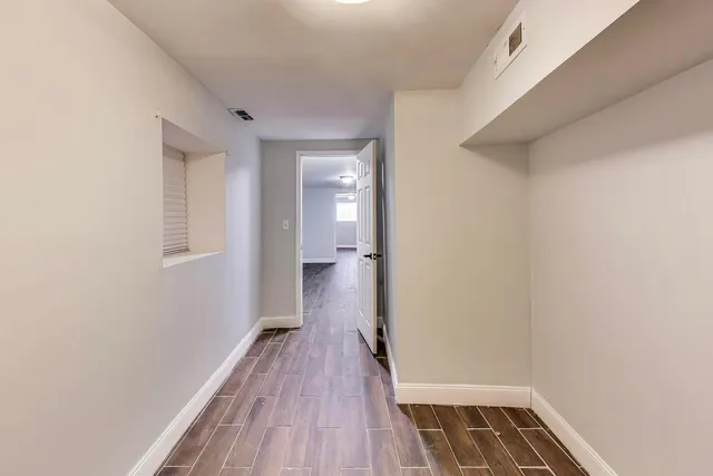 a view of a room with wooden floor and a staircase
