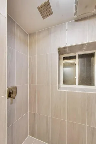 a bathroom with a shower and a sink