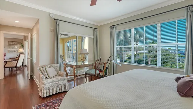 a bedroom with furniture and a large window