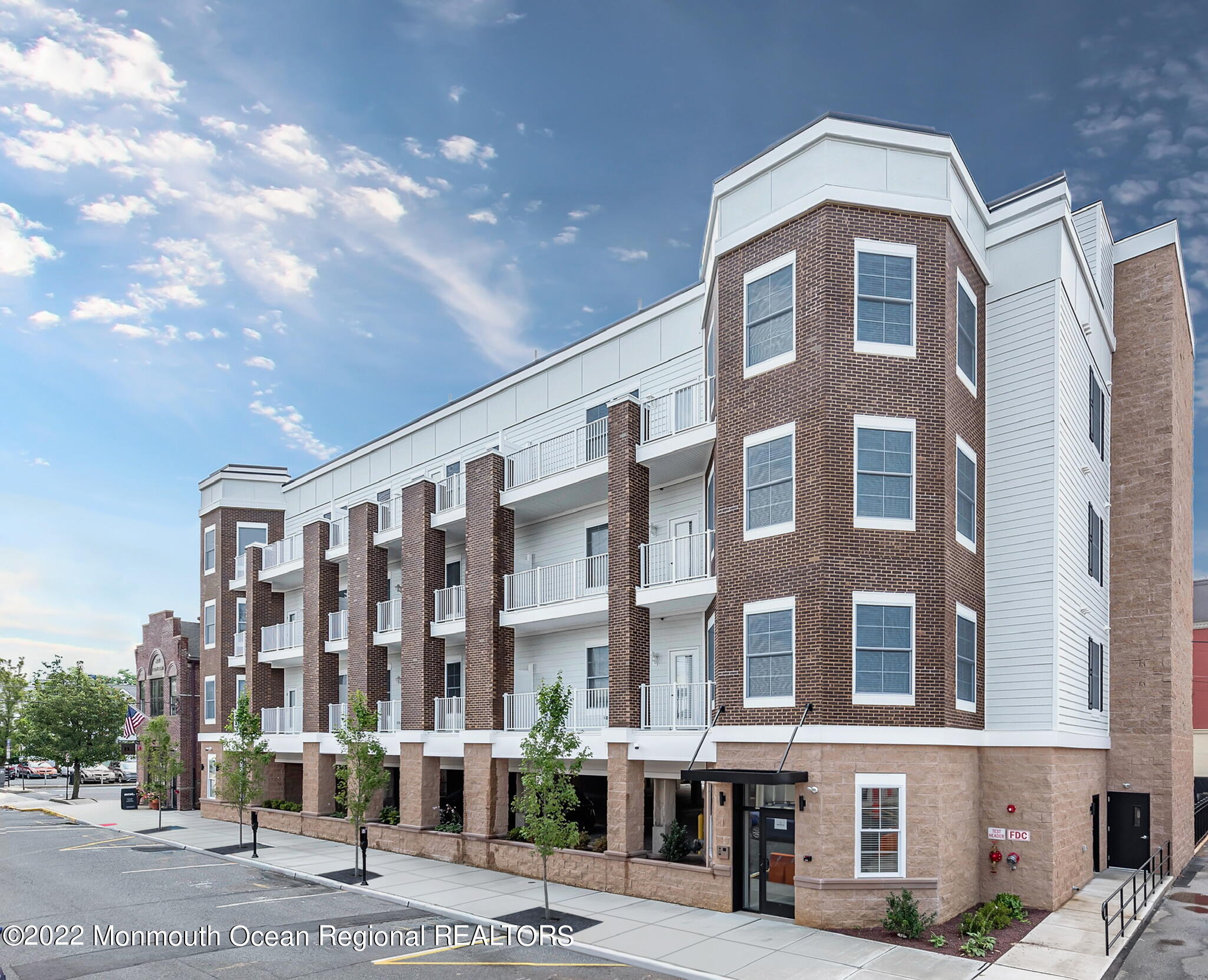 24 Mechanic Street, Unit 407 Red Bank, NJ 07701 - Photo 13 of 17 a front view of a building with street view