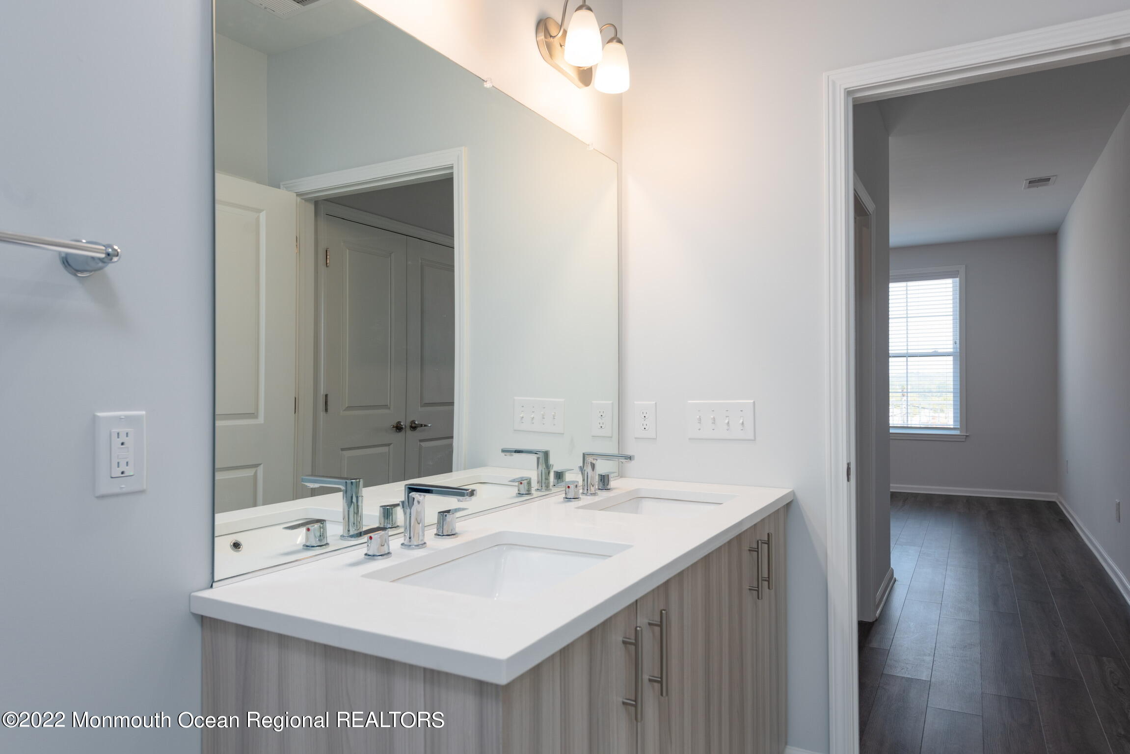24 Mechanic Street, Unit 407 Red Bank, NJ 07701 - Photo 5 of 17 a bathroom with a sink and a mirror