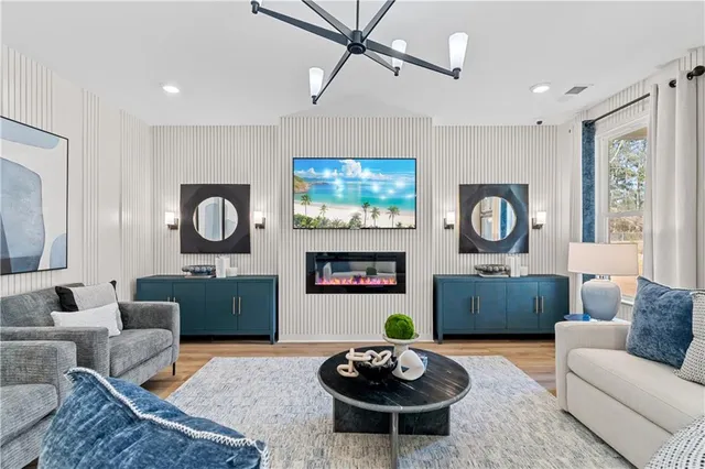 a living room with furniture chandelier and fireplace