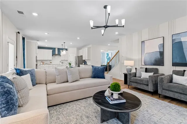 a living room with furniture and view of kitchen