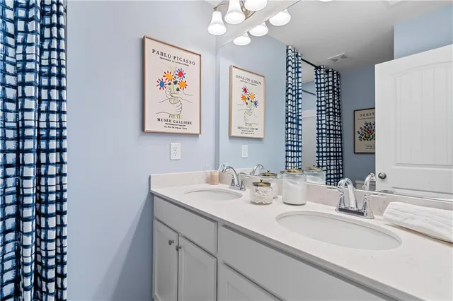 a bedroom with bed and wooden floor