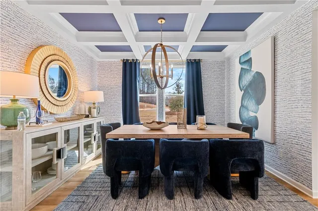 a large kitchen with a table and a clock on the wall