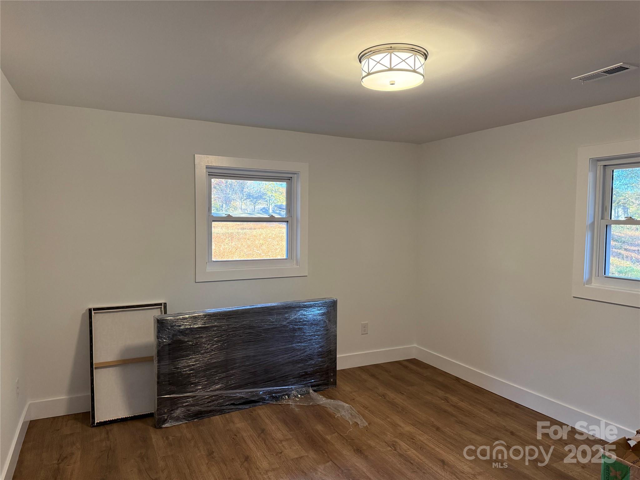 1208 Mariposa Road Stanley, NC 28164 - Photo 12 of 22 a view of room with hardwood floor and a window