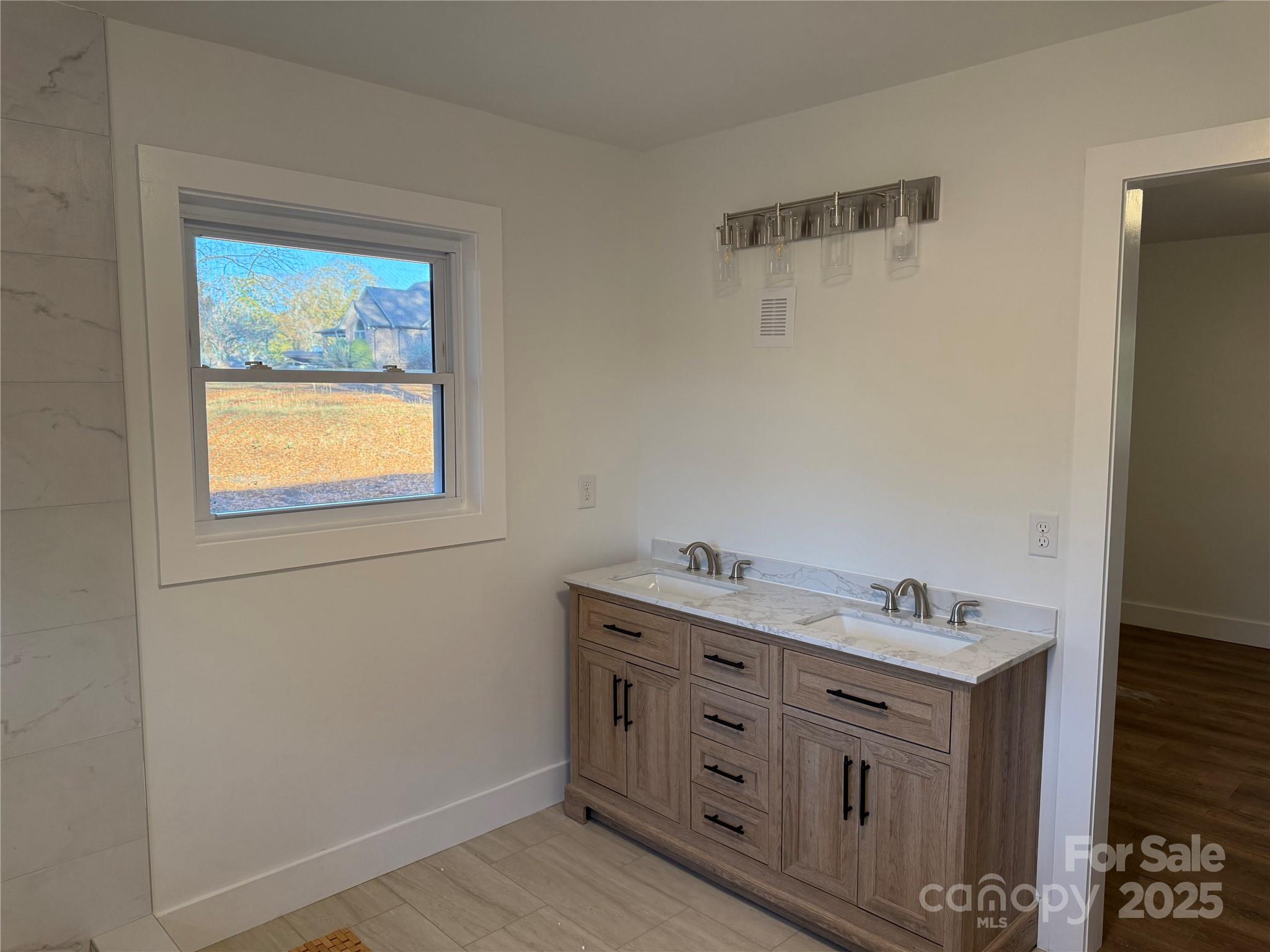 1208 Mariposa Road Stanley, NC 28164 - Photo 13 of 22 a bathroom with a window sink and mirror