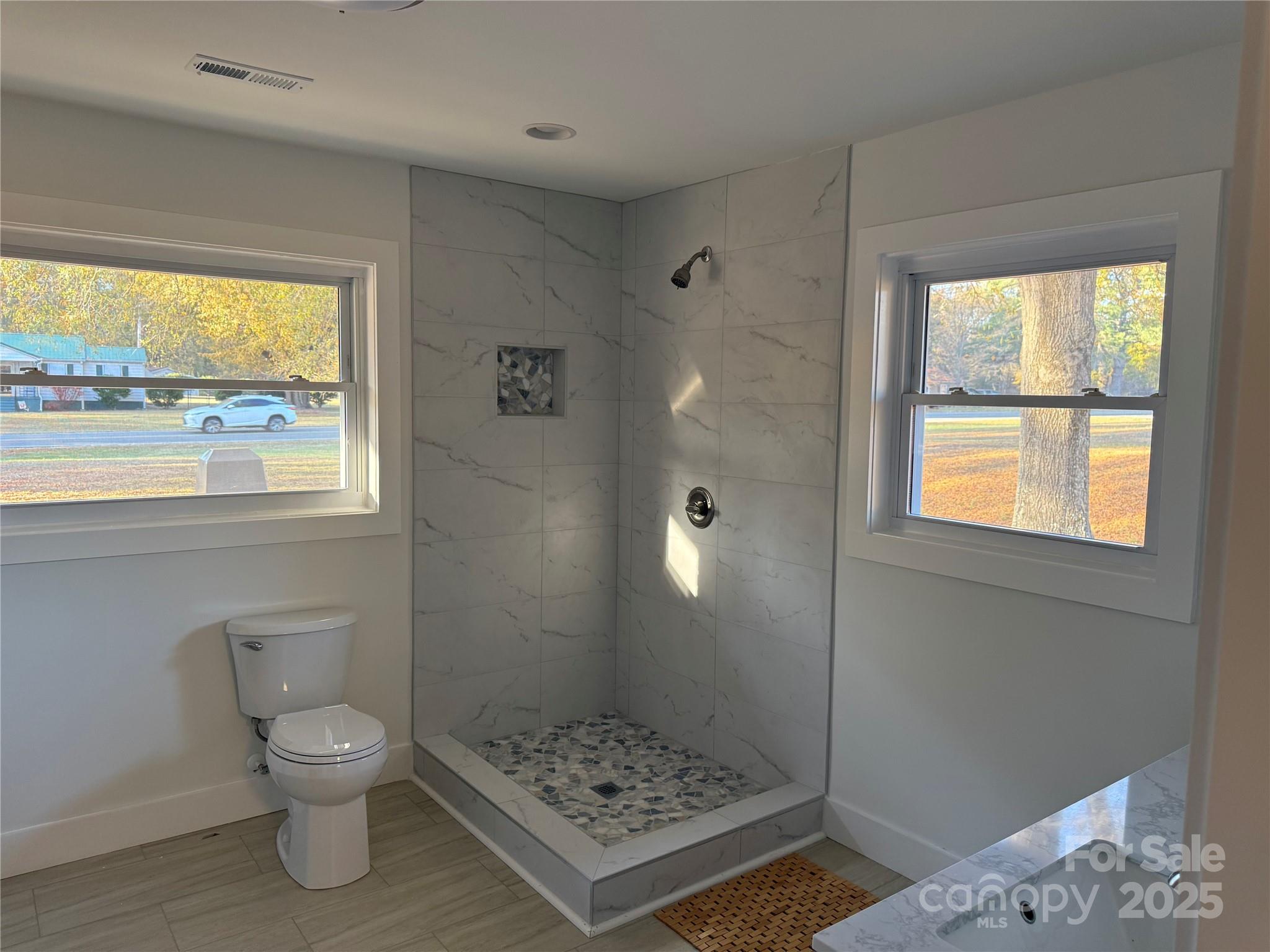 1208 Mariposa Road Stanley, NC 28164 - Photo 15 of 22 a bathroom with a toilet a sink and a window
