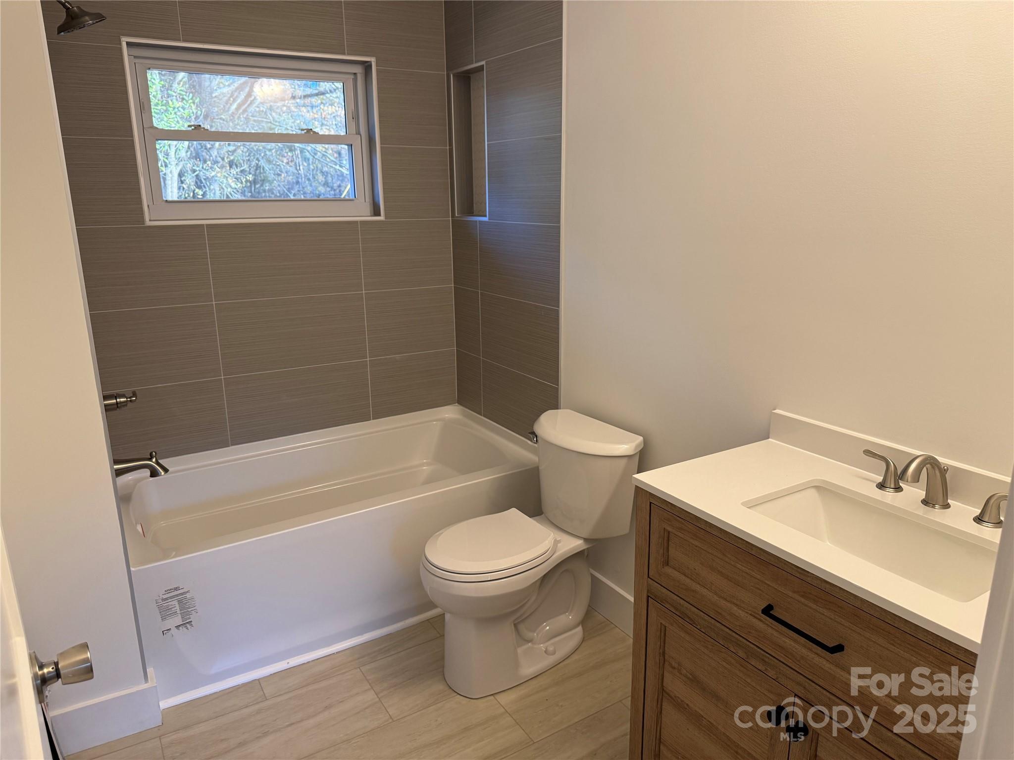 1208 Mariposa Road Stanley, NC 28164 - Photo 16 of 22 a bathroom with a sink toilet and bathtub