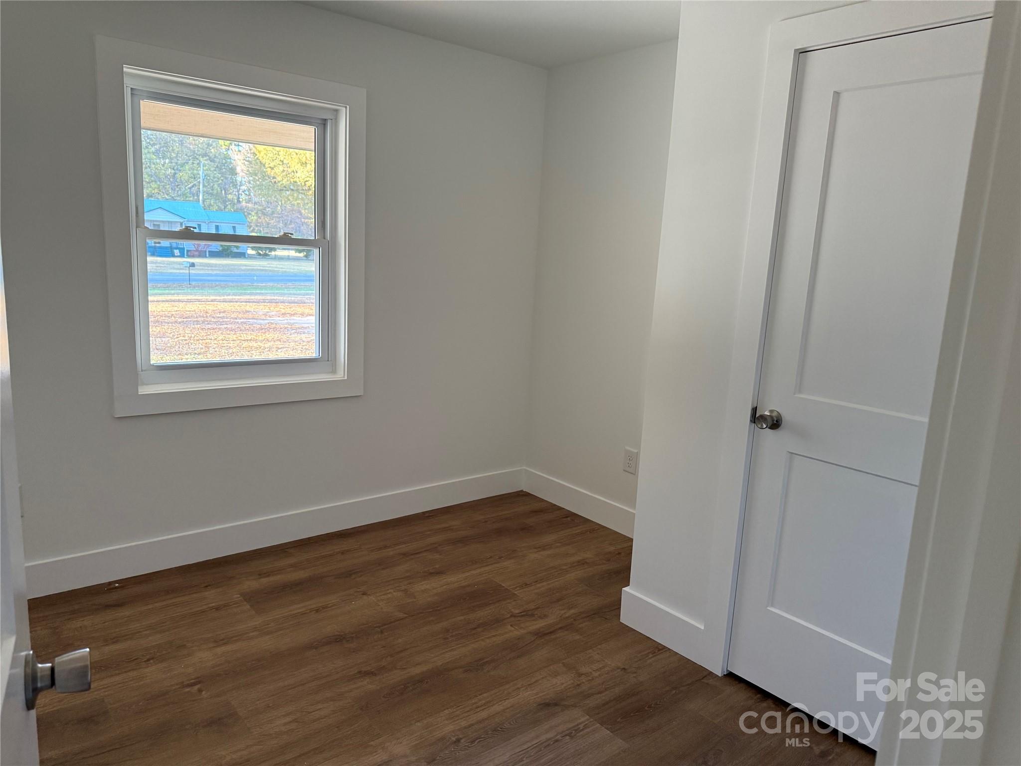 1208 Mariposa Road Stanley, NC 28164 - Photo 17 of 22 an empty room with wooden floor and windows