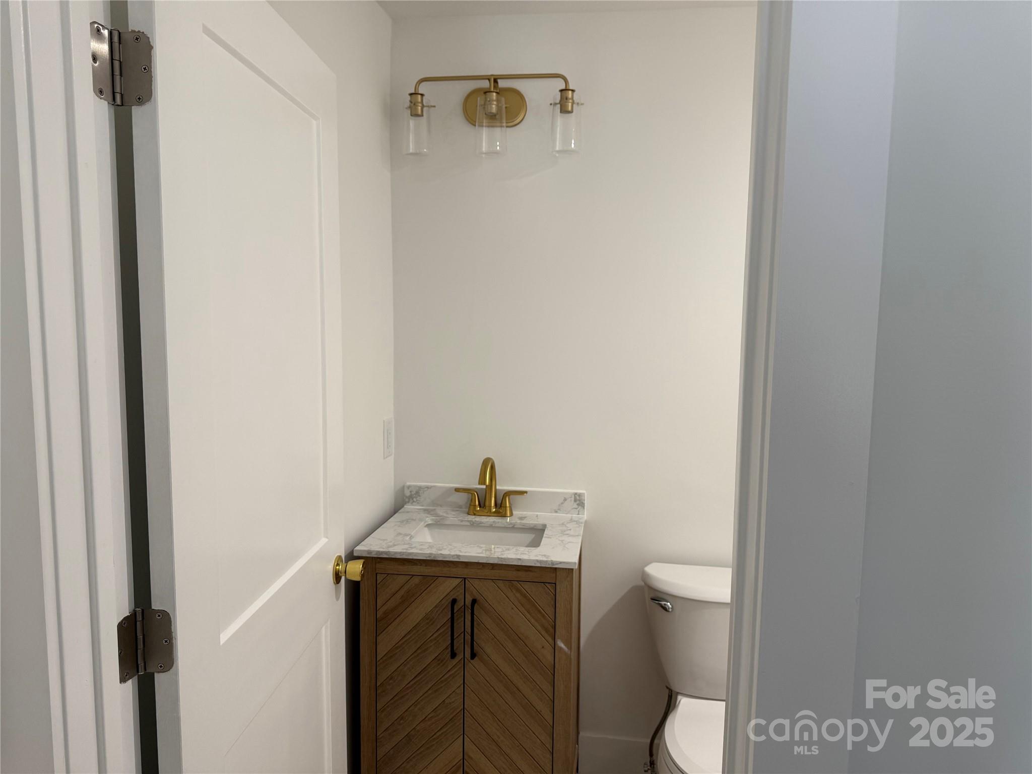 1208 Mariposa Road Stanley, NC 28164 - Photo 19 of 22 a bathroom with a sink toilet and vanity