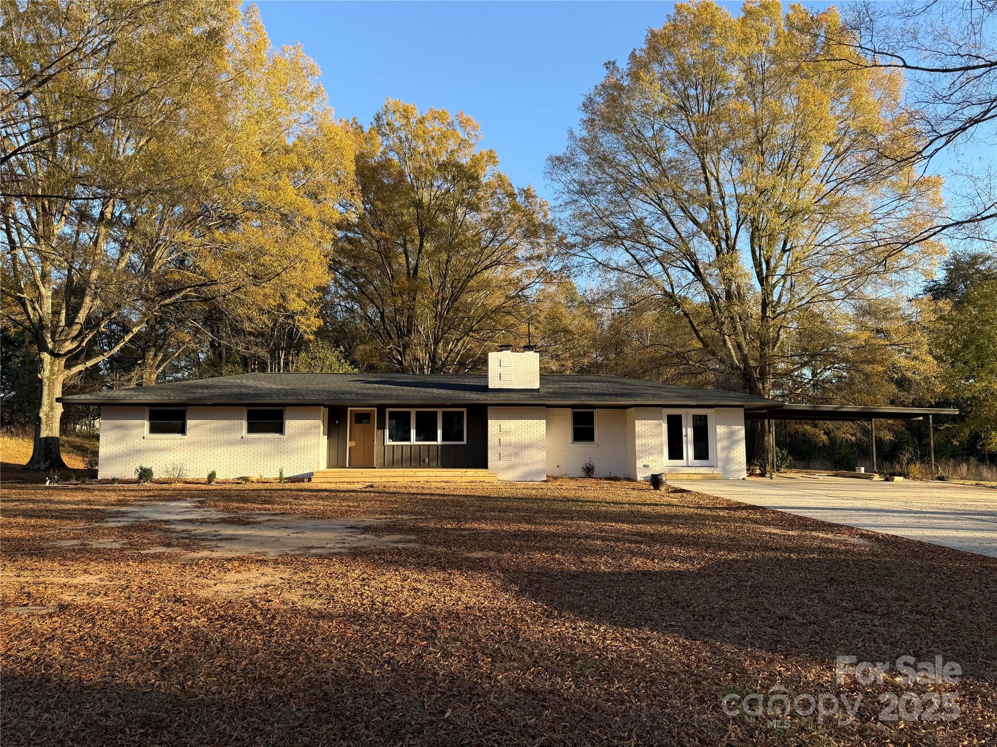 1208 Mariposa Road Stanley, NC 28164 - Photo 2 of 22 a front view of a house with large trees