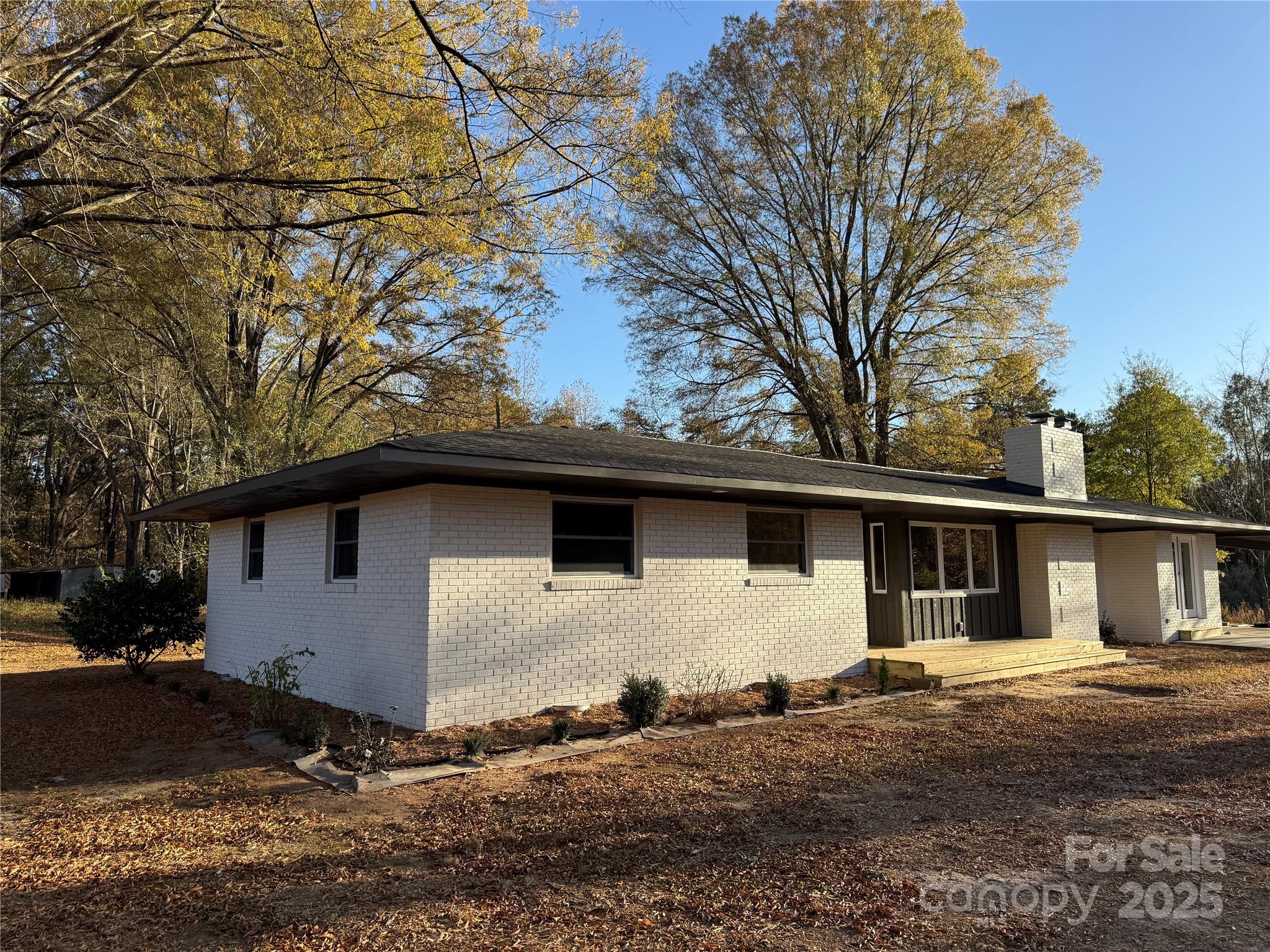1208 Mariposa Road Stanley, NC 28164 - Photo 4 of 22 a house with trees in the background