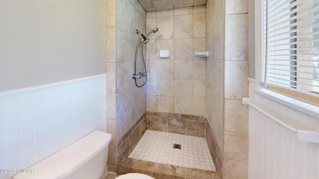 a bathroom with a tub and shower