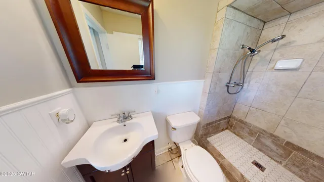 a bathroom with a sink mirror and toilet