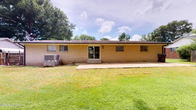a house view with swimming pool and trees in the background