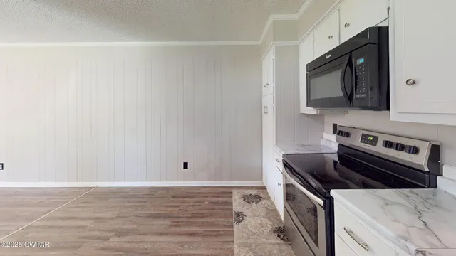 a kitchen with a stove and a microwave