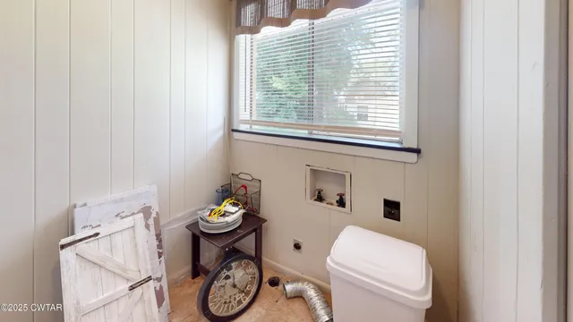 a bathroom with a toilet a sink and a window