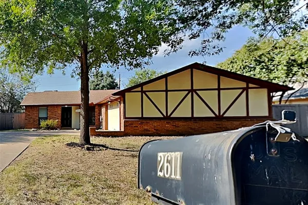 a front view of a house with parking area