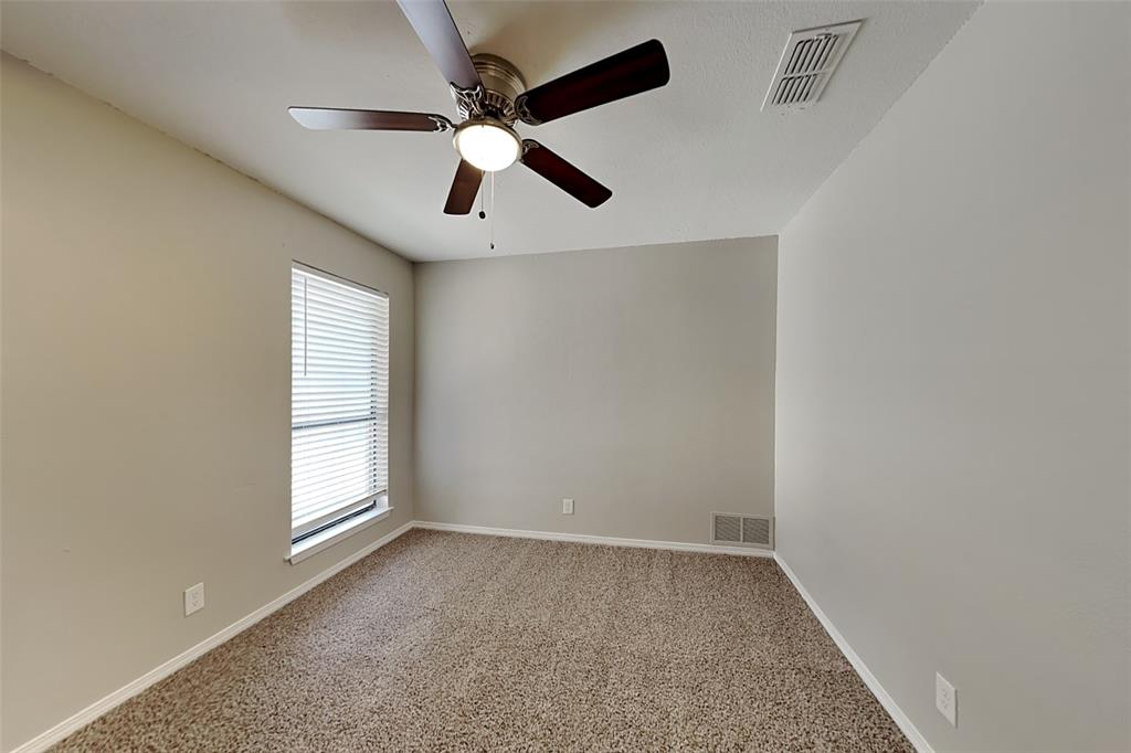 2611 Valley View Drive Corinth, TX 76210 - Photo 10 of 18 an empty room with windows and fan