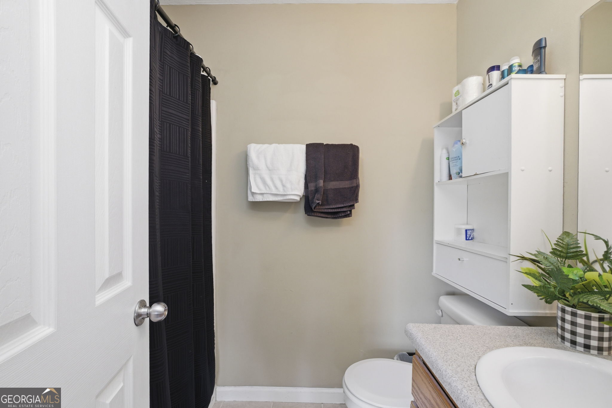 607 Thornton Street LaFayette, GA 30728 - Photo 19 of 25 a white toilet sitting next to a bathroom sink