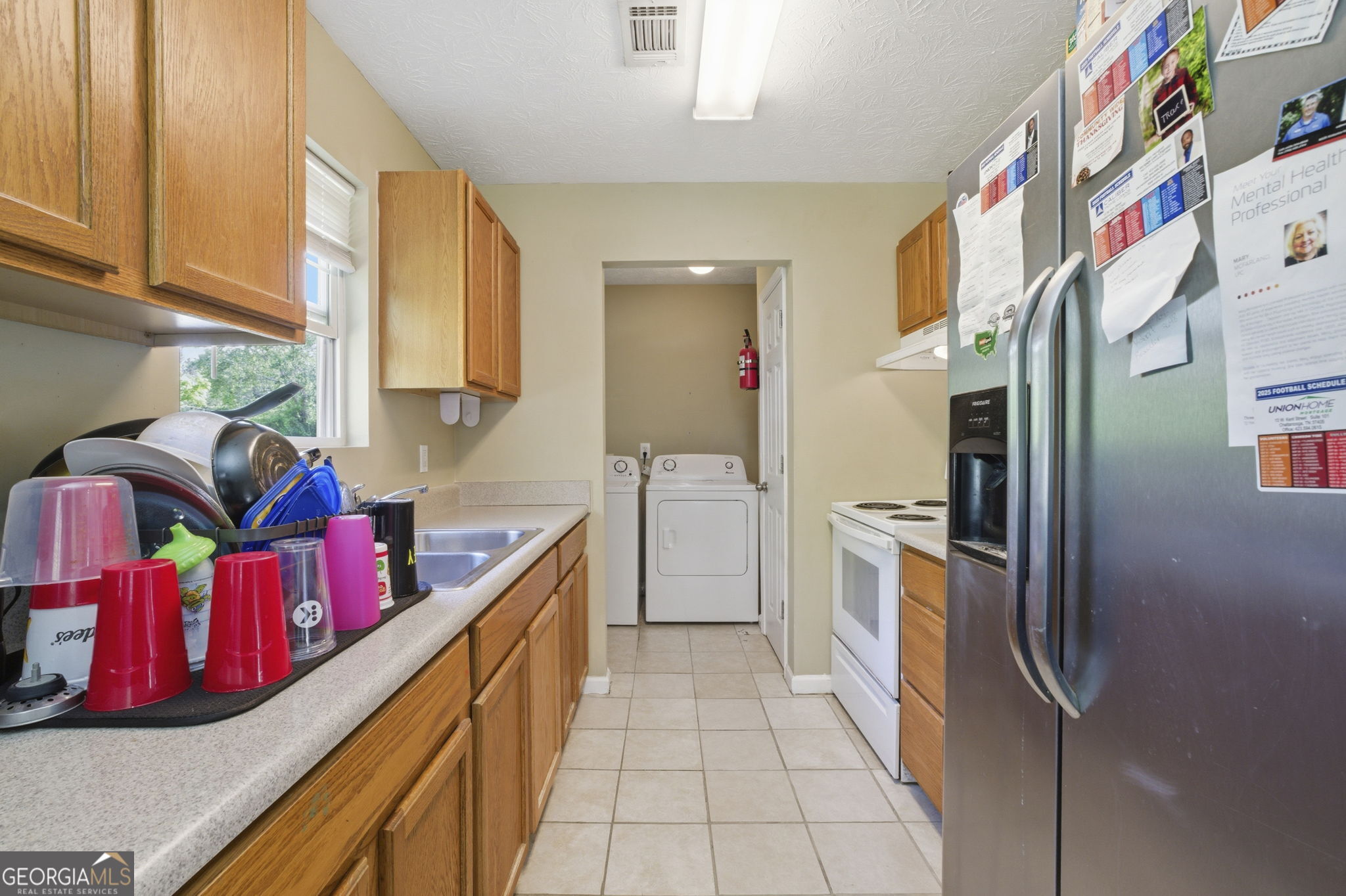 607 Thornton Street LaFayette, GA 30728 - Photo 8 of 25 a kitchen with stainless steel appliances granite countertop a refrigerator a stove and a sink