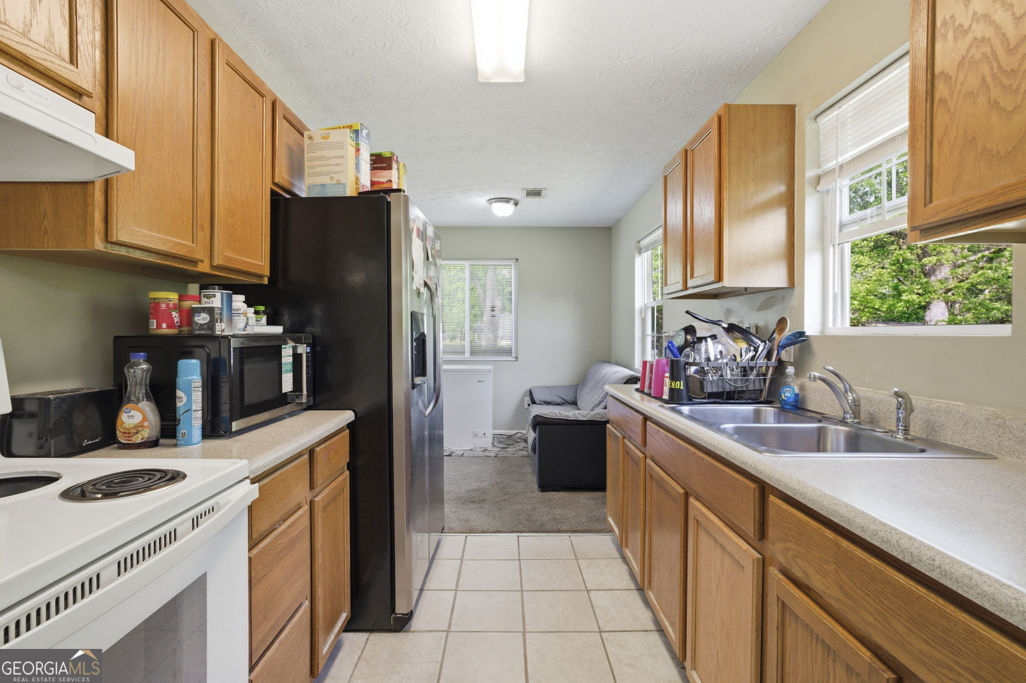 607 Thornton Street LaFayette, GA 30728 - Photo 9 of 25 a kitchen with a sink stove and refrigerator